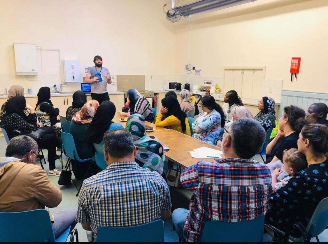 Group of people listening to a facilitator