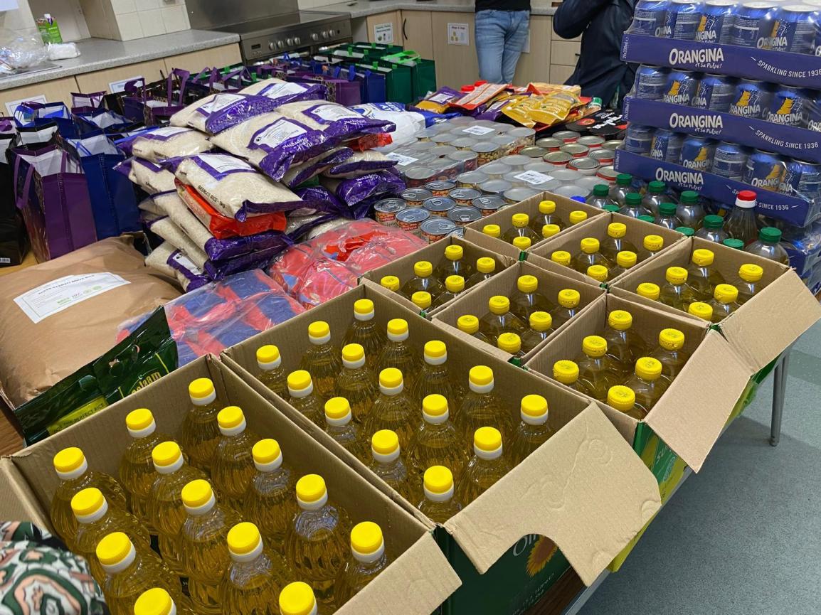 Stacks of clothes and boxes of bottles